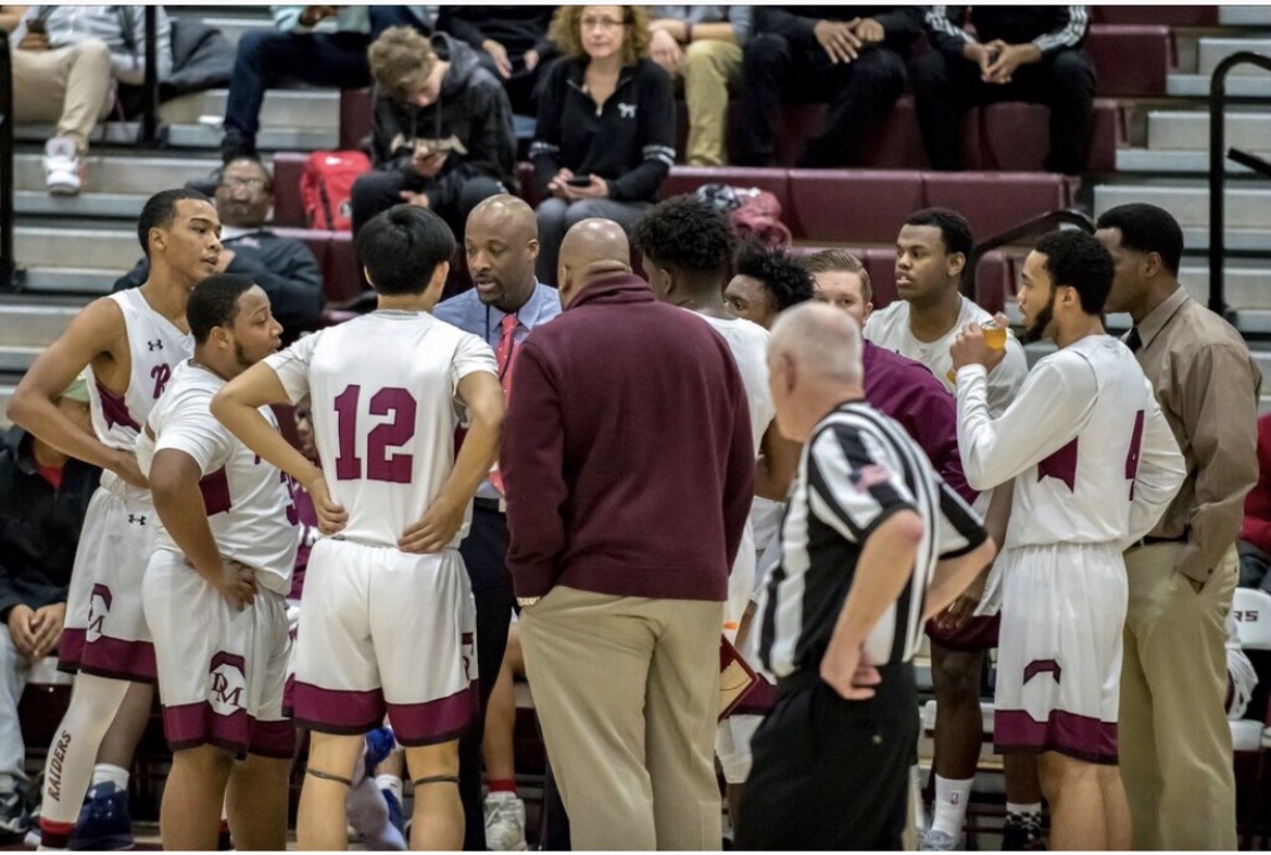 Coach Leo coaching during a team huddle